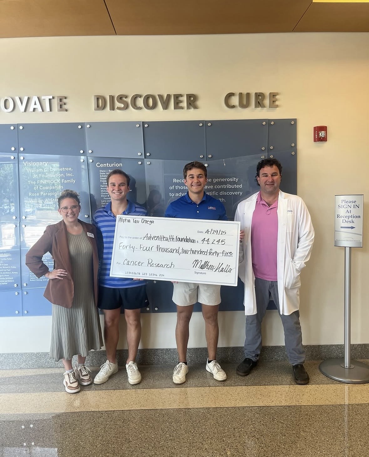 Brothers presenting check to AdventHealth Orlando